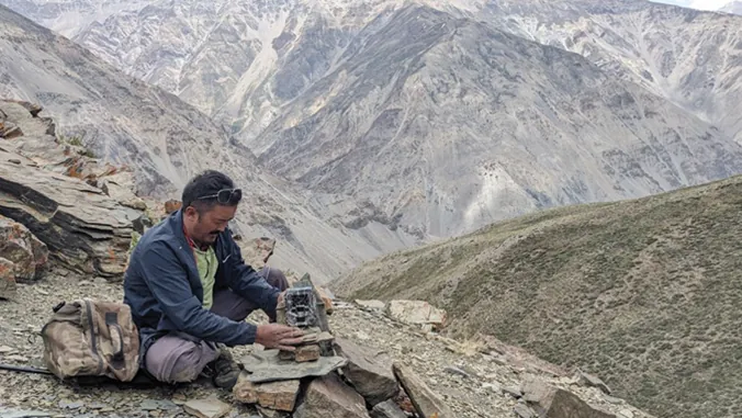Field team deploying a camera trap